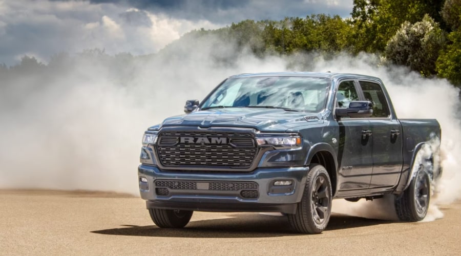 Front profile of a 2026 Ram 1500 driving through Mahwah showcasing its updated grille and LED lighting