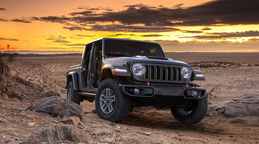 Dark grey 2026 Jeep Gladiator 4WD Mojave navigating a rocky trail with doors off, demonstrating open-air capability for off-road truck buyers in Ramsey and Mahwah, NJ