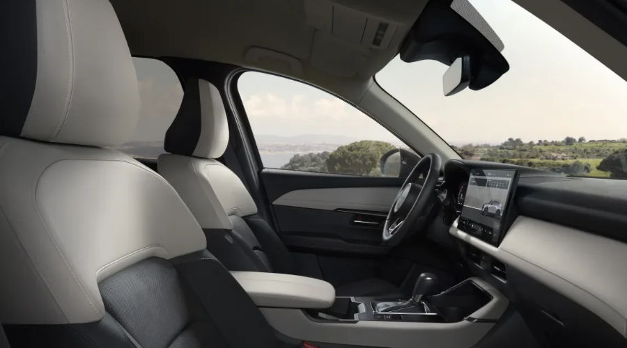 Spacious interior cabin of a 2026 Mazda CX-5 showing two-tone leatherette seats, central infotainment touchscreen, and windshield-mounted forward sensing camera housing, maintained by Ramsey Mazda in Bergen County, NJ