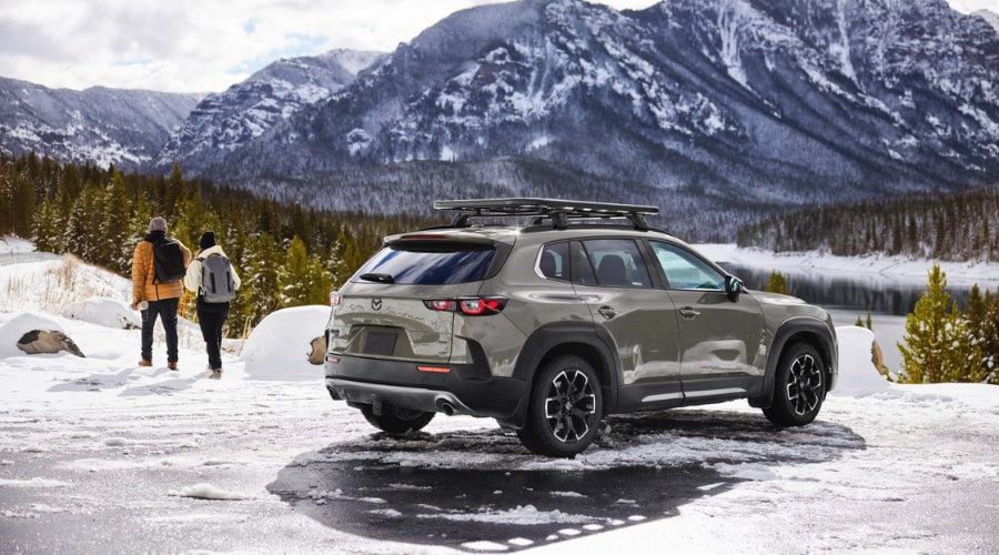 Side profile of a sleek 2026 Mazda CX-50 accelerating swiftly down a highway near Paramus