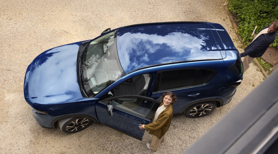 Overhead view of a blue 2026 Mazda CX-5 with an open door, highlighting a safe family commuter option for residents in Ramsey, NJ