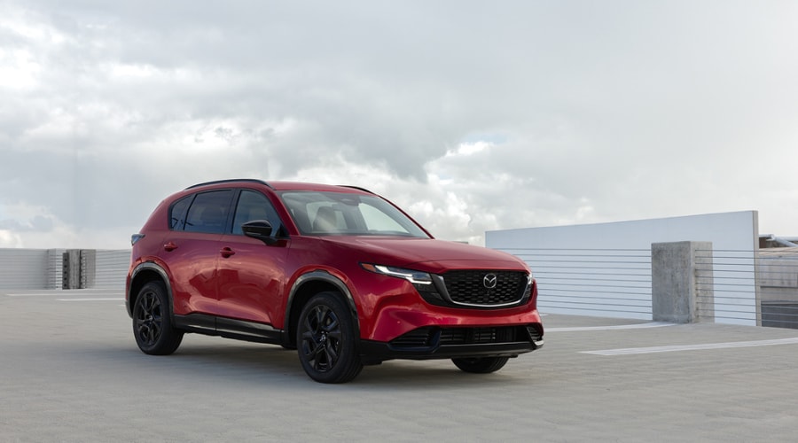 Side profile of a 2026 Mazda CX-5 parked near Finch Park in Ramsey showcasing its thick acoustic glass and premium dark paint finish.