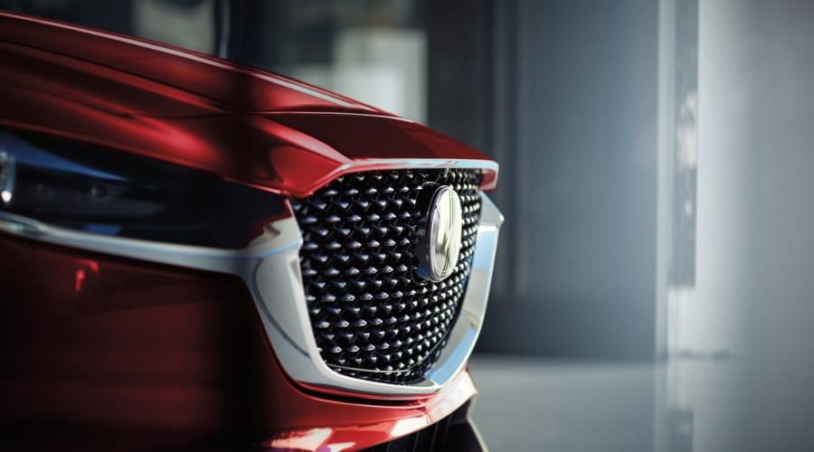Close-up view of the Soul Red Crystal metallic front grille and chrome wing trim on the 2026 Mazda CX-30 exterior, showcasing premium crossover design craftsmanship available at Ramsey Mazda in Bergen County, NJ.