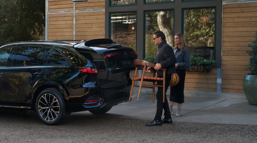 A 2026 Mazda CX-90 driving through Mahwah showcasing its modern dashboard and Center Infotainment display of 10.25-inch screen