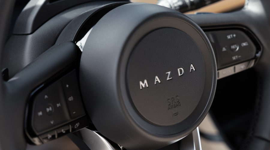 Close up view of the physical six speed automatic gear selector inside the quiet cabin of a 2026 Mazda CX-5.