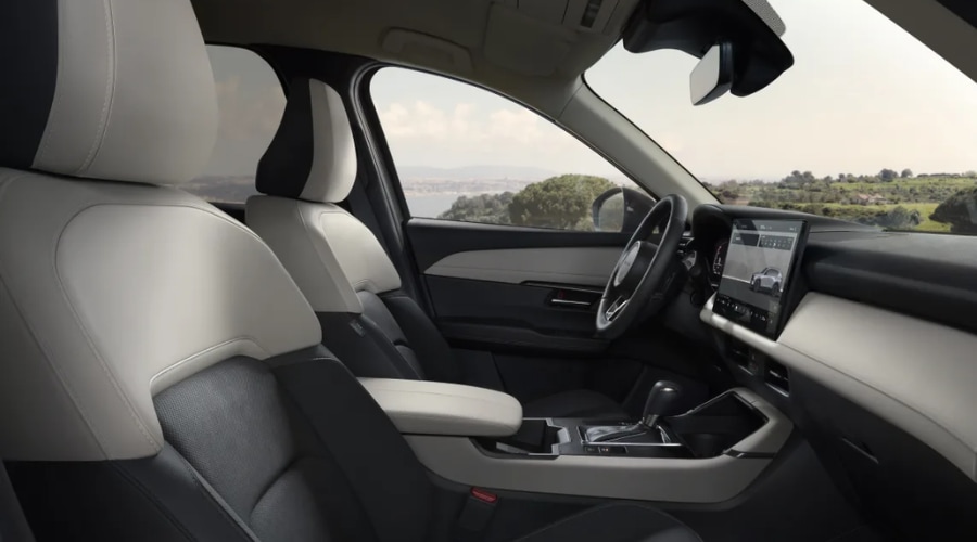 Spacious interior cabin of the 2026 Mazda CX-5 featuring two-tone black and cream leatherette seats, touchscreen infotainment display, and ergonomic center console for comfortable commutes in Ramsey, NJ