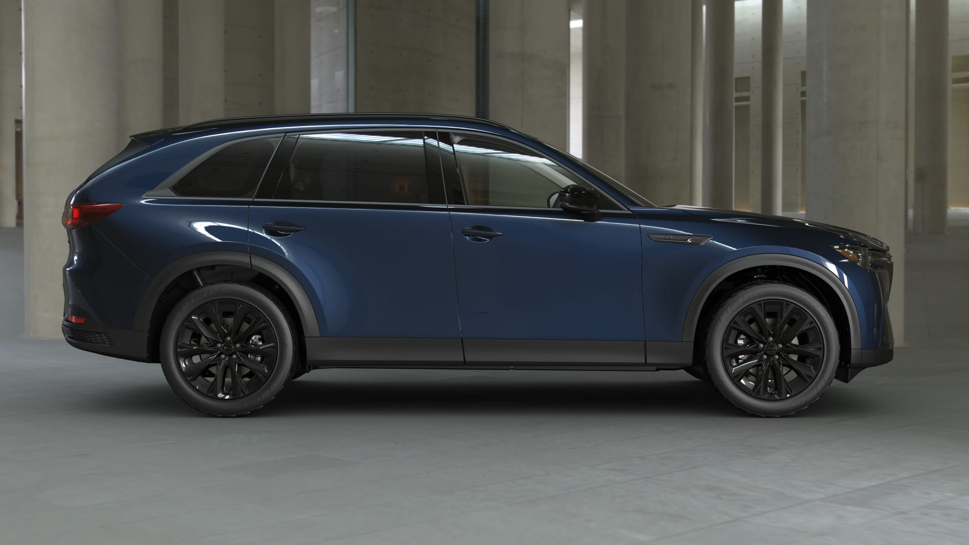 Rear angle of the Mazda CX-90 in Jet Black Mica with dark alloy wheels.
