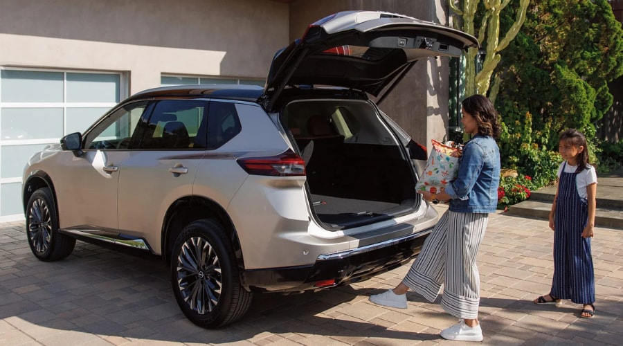 Rear view of a 2026 Nissan Rogue parked in Ramsey New Jersey showing the wide open rear liftgate and low loading floor layout