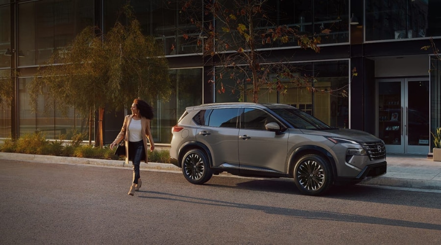 Front profile of a 2026 Nissan Rogue AWD in Ramsey driving through a light winter slush showing its confident stance.