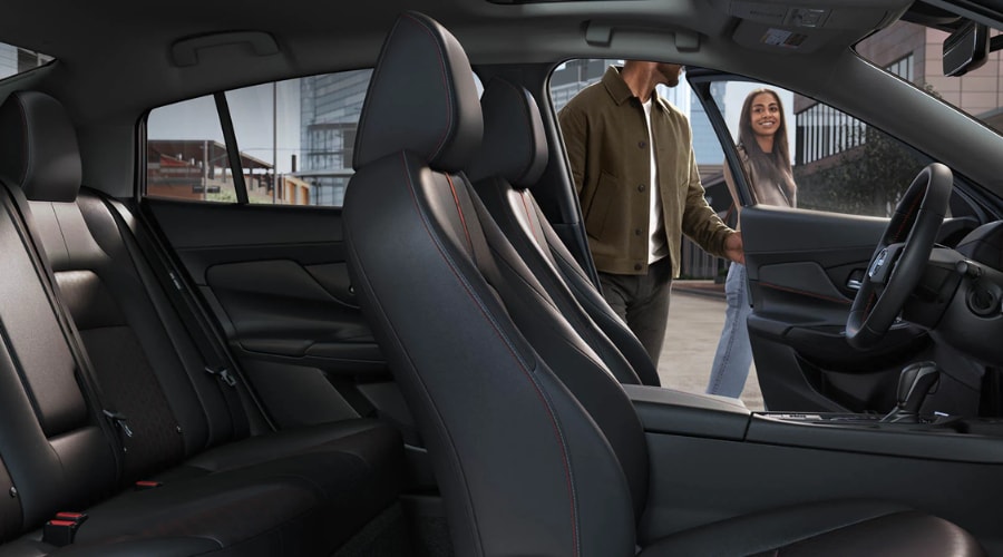Spacious 2026 Nissan Sentra interior featuring supportive front Zero Gravity seats with orange contrast stitching, generous rear passenger space, and modern touchscreen dashboard for commuters in Ramsey and Paramus, NJ.