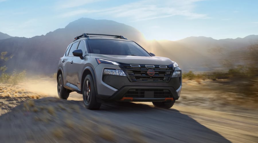 Side profile of a 2026 Nissan Rogue driving down Route 17 in New Jersey demonstrating its tight handling and urban maneuverability