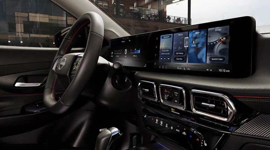 Close-up of the 2025 Nissan Sentra center touchscreen display showing menu app shortcuts, Bluetooth device controls, and customizable driver settings for commuters in Ramsey, NJ.