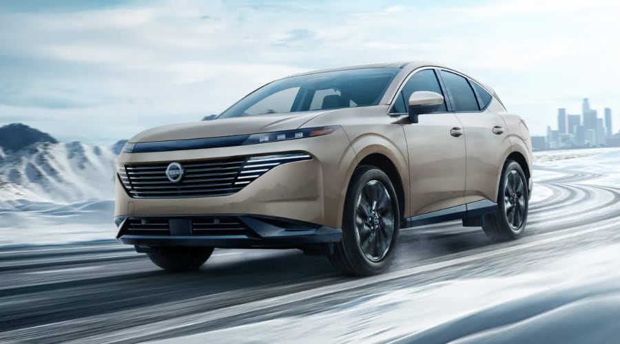 Champagne gold 2026 Nissan Murano driving on an icy, snow-covered road, highlighting Intelligent AWD weather capability for Bergen County, NJ winter commutes.