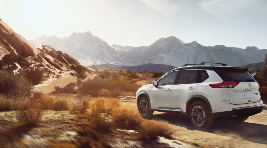2026 Nissan Rogue navigating a winding road in Rockland showing off its handling precision.