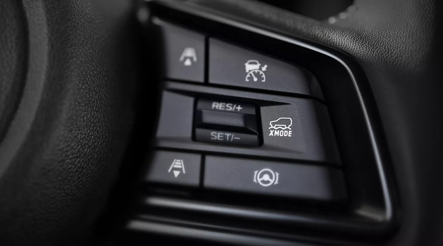 Close-up of the steering wheel control buttons on a Subaru Outback showing the dedicated X-MODE toggle button, adaptive cruise control, and lane keep assist switches for drivers in Ridgewood and Ramsey, NJ.