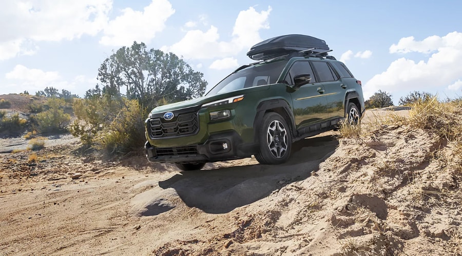 A 2026 Subaru Outback driving off-road near Ramsey, NJ showcasing its 8.7 inches of ground clearance and rugged exterior