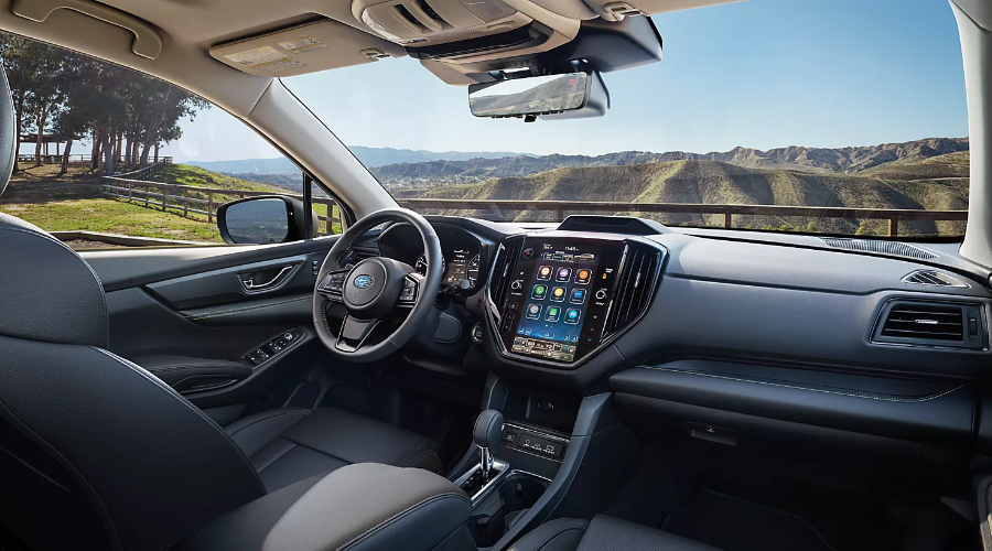 Modern front cabin cockpit of the 2027 Subaru Ascent featuring black leather seats, a leather-wrapped steering wheel, and a center-mounted portrait-style 11.6-inch touchscreen display available at Ramsey Subaru in Bergen County, NJ. 