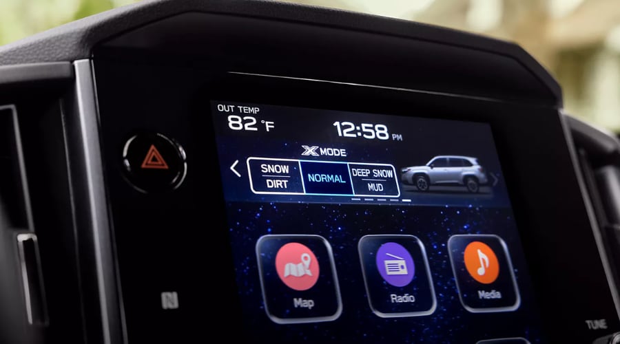 Close-up view of the 2026 Subaru Forester touchscreen display showing Dual-Function X-MODE settings, including Snow/Dirt and Deep Snow/Mud traction modes for off-road driving in Ramsey, NJ.
