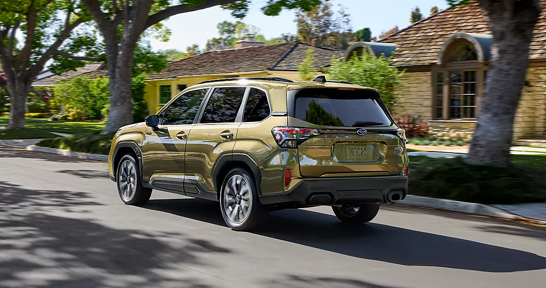 Side profile view of a 2026 Subaru Forester Touring Hybrid shown in Autumn Green Metallic.