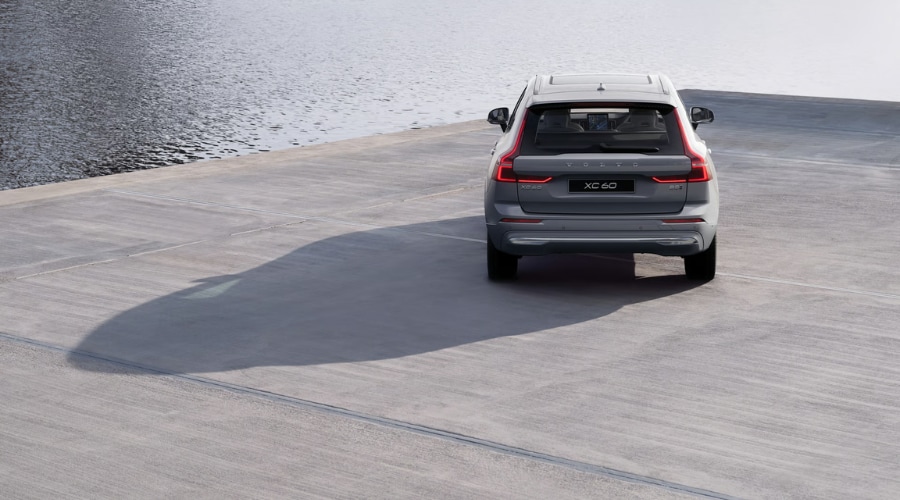 Rear profile view of the 2026 Volvo XC60 B5 AWD in Platinum Grey showing signature LED taillights near Ramsey and Upper Saddle River, NJ