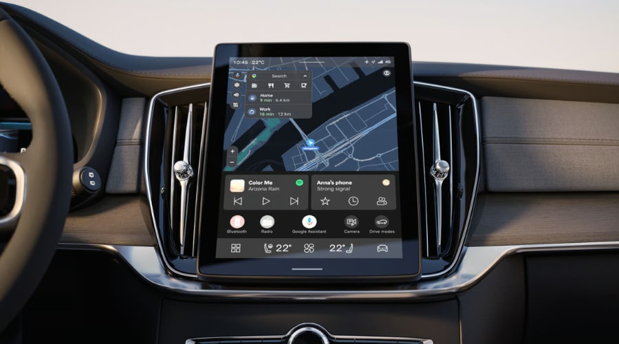Close-up view of the 2026 Volvo XC90 vertical center touchscreen display running Google built-in software, displaying Google Maps navigation with saved Home and Work routes, Google Assistant icons, and dual-zone climate controls for Bergen County commuters.