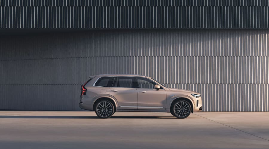 Full side profile view of a 2026 Volvo XC90 luxury SUV in Bright Dusk metallic finish with multi-spoke alloy wheels, showcasing sleek Scandinavian design for Bergen County families in Ramsey and Mahwah, NJ.