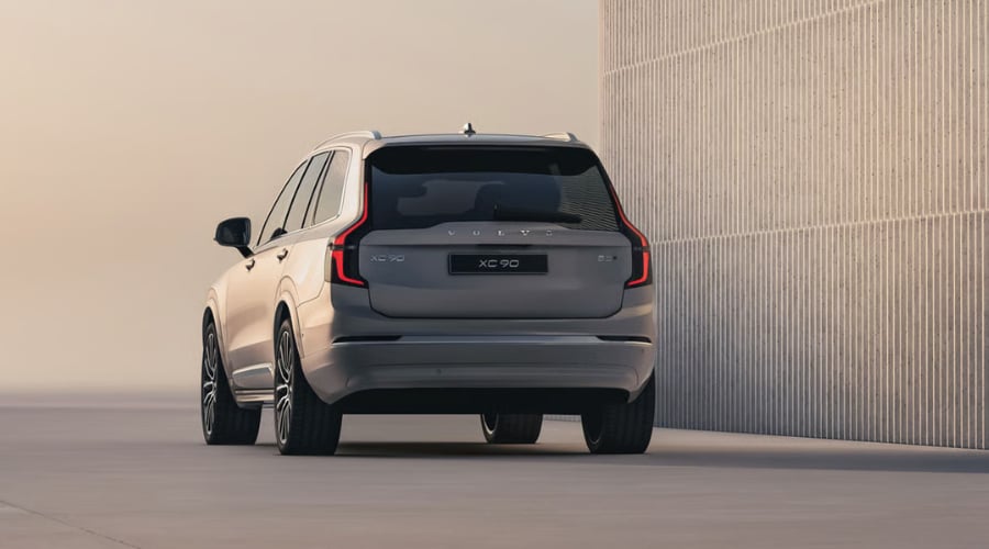 Rear three-quarter view of the 2026 Volvo XC90 luxury SUV showing vertical LED taillights, rear Cross Traffic Alert bumper sensors, and BLIS side mirror indicators designed for safe reversing and parking in Ramsey and Wyckoff, NJ.