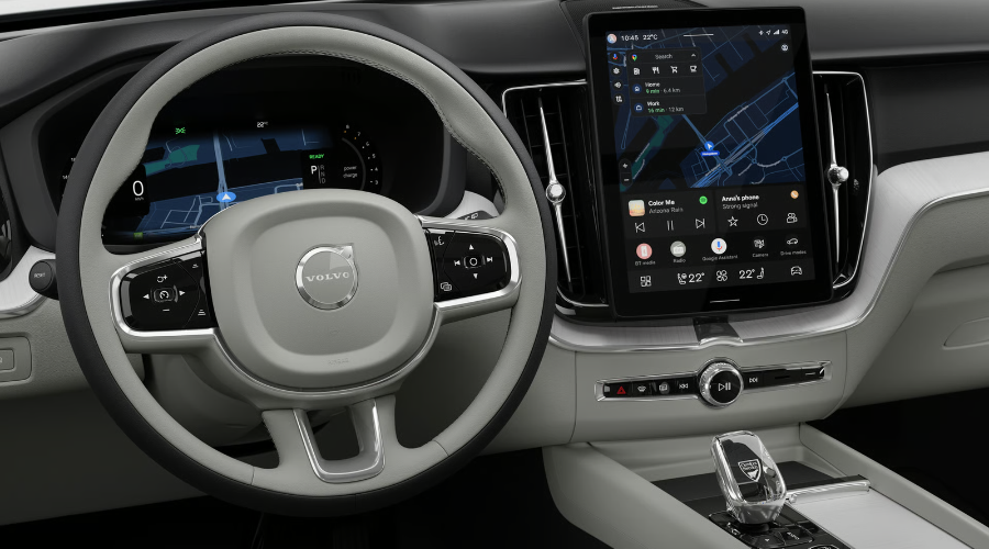 Driver perspective of the 2027 Volvo XC60 cockpit highlighting the new standalone 11.2-inch central display with Google built-in navigation, digital driver gauge cluster, light grey two-tone leather steering wheel, and Orrefors crystal gear shifter at Volvo Cars Ramsey serving Bergen County drivers.