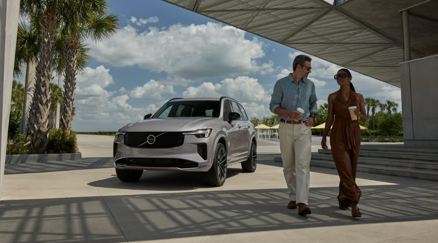 Front three-quarter view of the 2026 Volvo XC90 Plug-in hybrid in Platinum Grey with its driver-side fender charging port visible, representing the ideal premium family SUV for daily commutes in Saddle River and Mahwah, NJ