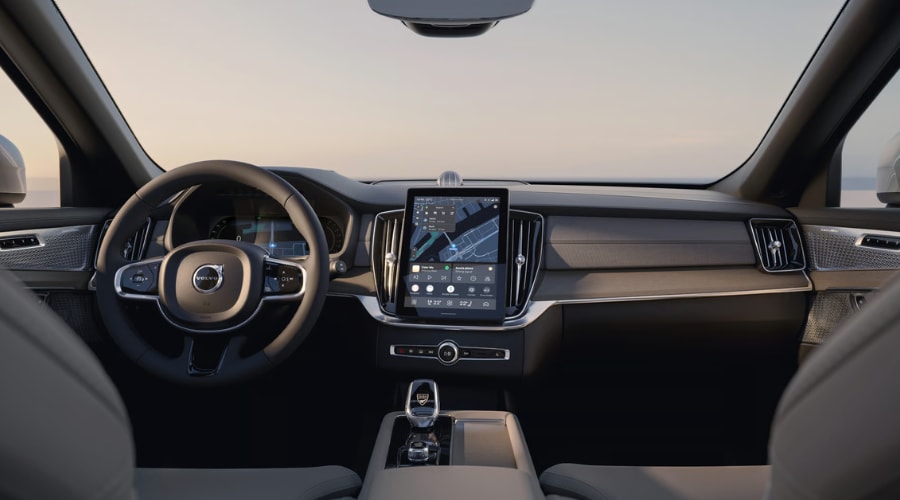 Front cabin dashboard view of a 2026 Volvo XC90 luxury SUV featuring an Orrefors crystal gear shifter, large vertical touchscreen navigation display, and Scandinavian wood trim designed for quiet Route 17 commutes in Ramsey and Upper Saddle River, NJ.