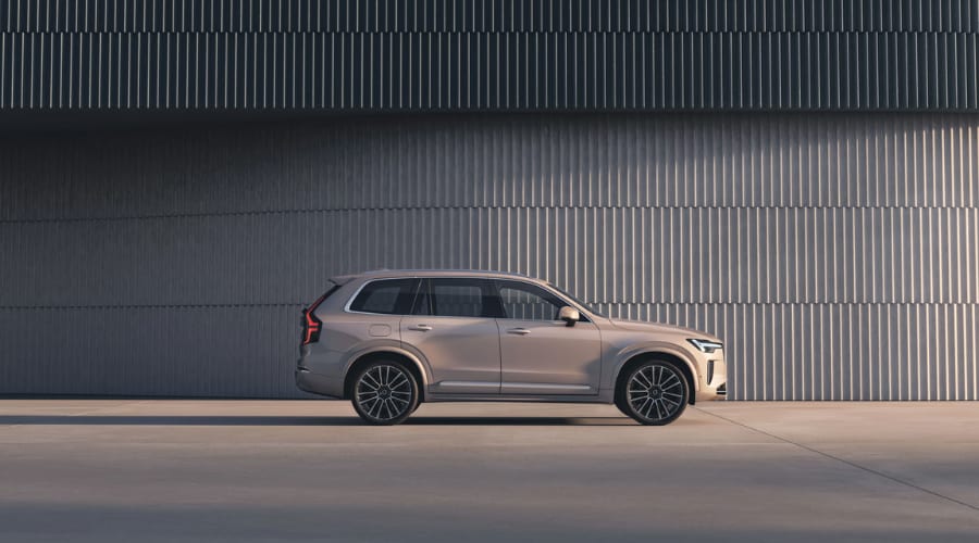 Full side profile view of the 2026 Volvo XC90 luxury SUV featuring multi-spoke alloy wheels, acoustic window glass, and side-mirror sensor housings for smooth commuting through Ramsey and Upper Saddle River, NJ.