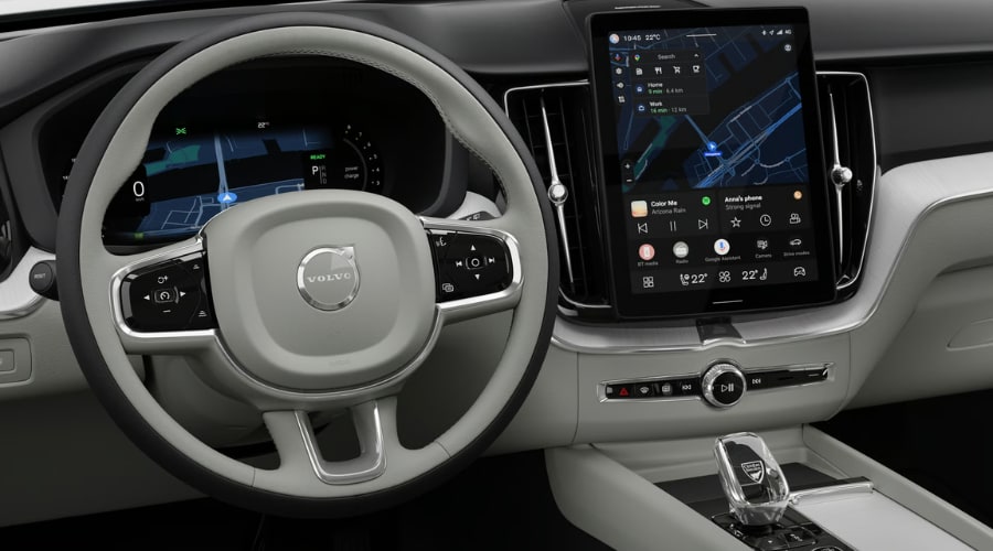 Center touchscreen with Google Maps navigation and tactile steering wheel controls inside the 2026 Volvo XC60 for Bergen County and Route 17 drivers in Ramsey, NJ