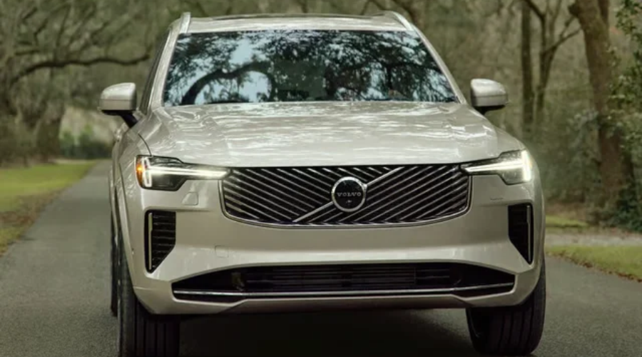 Front view of the new 2027 Volvo XC90 B5 Core AWD luxury SUV in Sand Dune finish, showcasing updated diagonal front grille, restyled Thor's Hammer LED headlights, and silver roof rails available at Volvo Cars Ramsey in Ramsey, NJ.