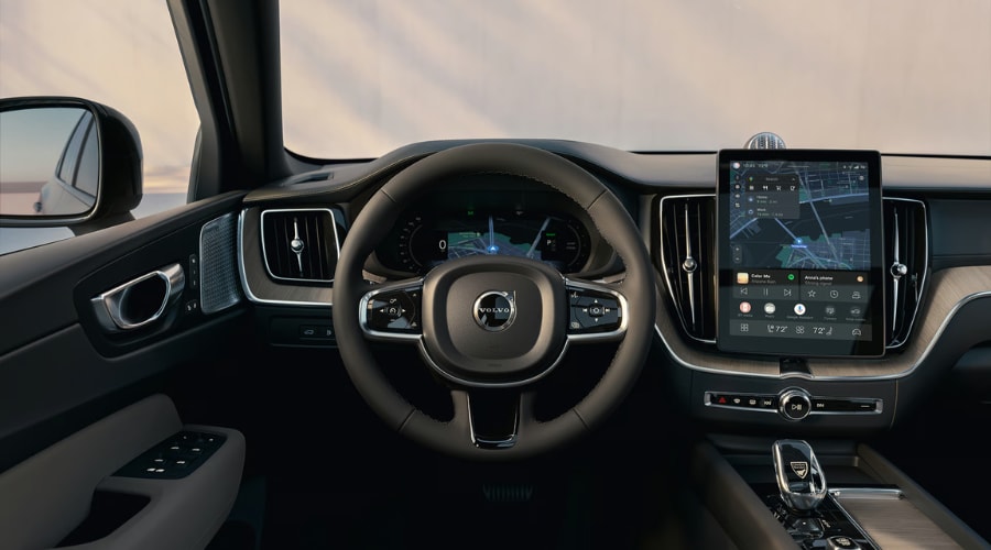 A customer reviewing the digital display inside a 2026 Volvo XC60 Plug-In Hybrid at Volvo Cars Ramsey before going for a local test drive