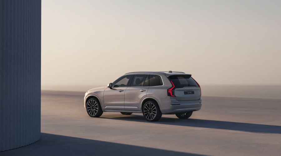 Rear three-quarter view of a 2026 Volvo XC90 luxury SUV showing signature vertical LED taillights and multi-spoke wheels, ideal for Bergen County families comparing three-row crossovers in Ramsey, NJ.