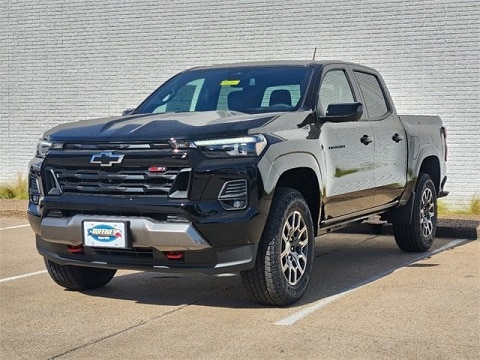 black 2024 Chevrolet Colorado truck parked at the Huffines Chevrolet Plano dealership in Plano, TX