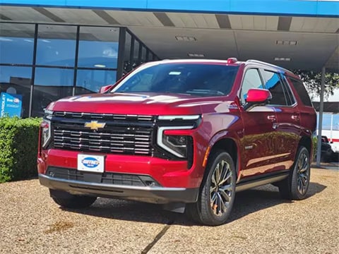 red 2026 Chevy Tahoe SUV parked at the Huffines Chevrolet Plano dealership in Plano, TX