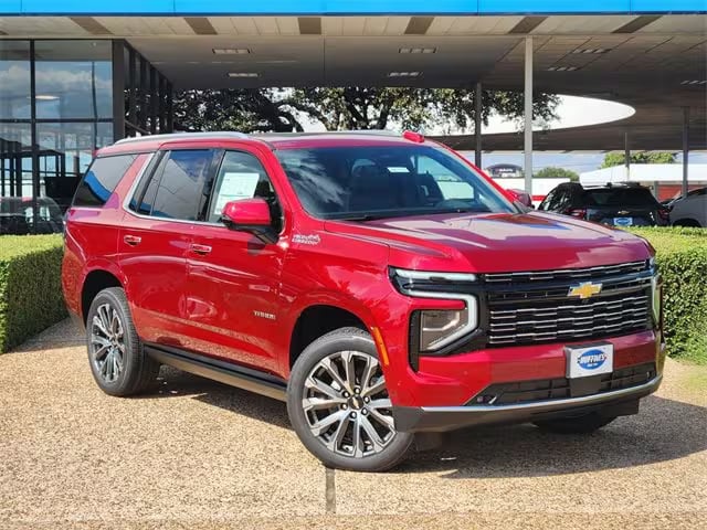 red 2026 Chevrolet Tahoe SUV parked at the Huffines Chevrolet Plano dealership in Plano, TX