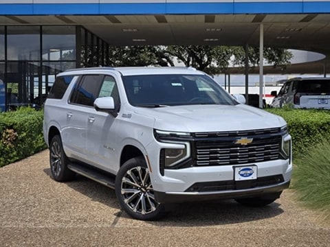 white 2026 Chevrolet Suburban SUV parked at the Huffines Chevrolet Plano dealership in Plano, TX