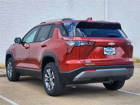 red 2025 Chevrolet Equinox crossover parked at the Huffines Chevrolet Plano dealership in Plano, TX