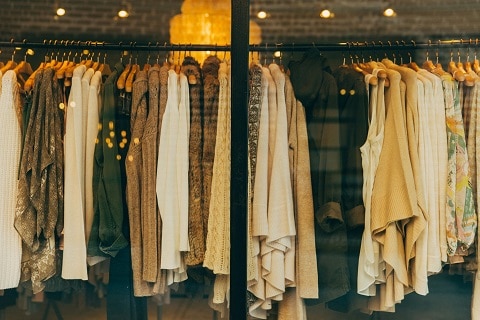 clothes hanging on a rack at a boutique in plano, tx