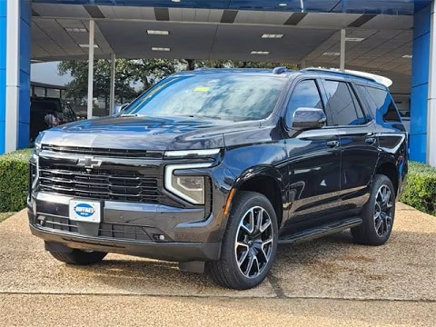 black 2025 Chevy Tahoe SUV parked at the Huffines Chevrolet Plano dealership in Plano, TX