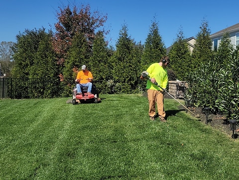 landscapers mowing a lawn