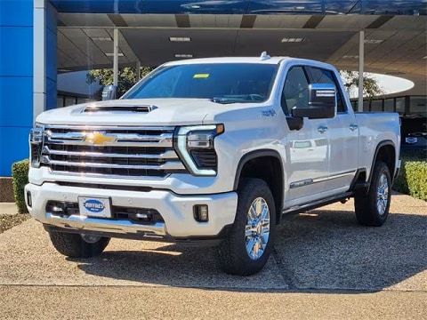 white 2025 Chevy 2500 truck parked at the Huffines Chevrolet Plano dealership in Plano, TX