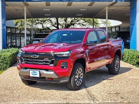 red 2026 Chevrolet Colorado truck parked at the Huffines Chevrolet Plano dealership in Plano, TX