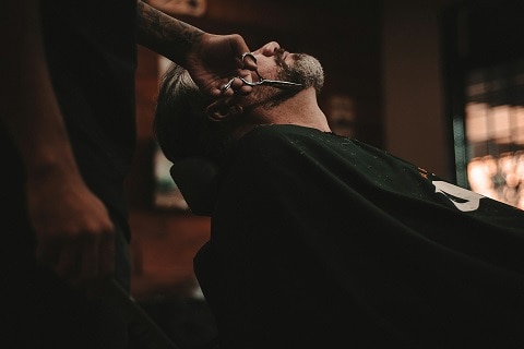 person getting their hair cut at a barber shop in plano, tx