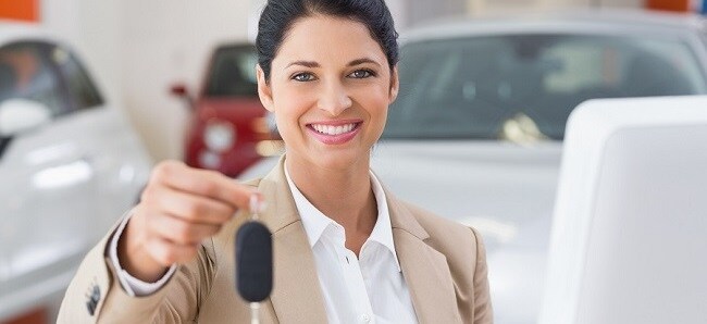 Saleswoman Handing Off Keys