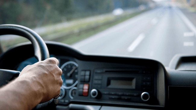 Drivers hand on steering wheel heading down the highway, representing Mitsubishi SUV use in Berks County, PA