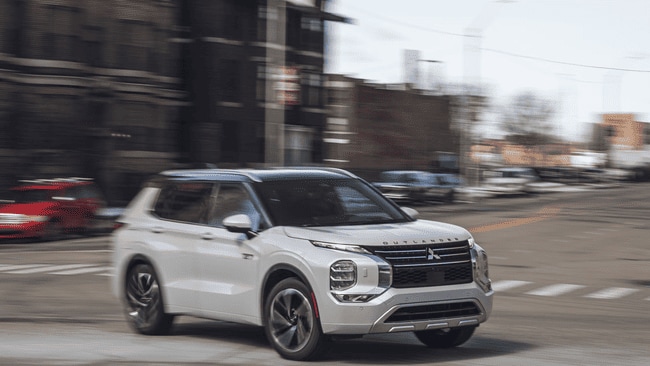 Mitsubishi Outlander driving through Berks County roads highlighting reliable SUV performance for local drivers