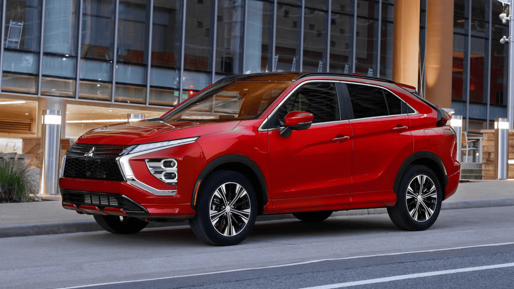 Red 2025 Mitsubishi Eclipse Cross parked outside modern building highlighting sleek design and performance features